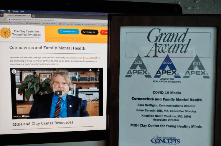 Photo of APEX Grand Award certificate alongside Clay Center winning webpage