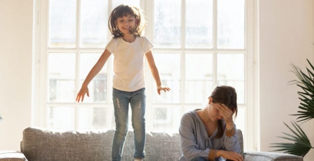 Anger - Knowing what sets you off - Girl jumping on a couch while a frustrated mom sits next to her