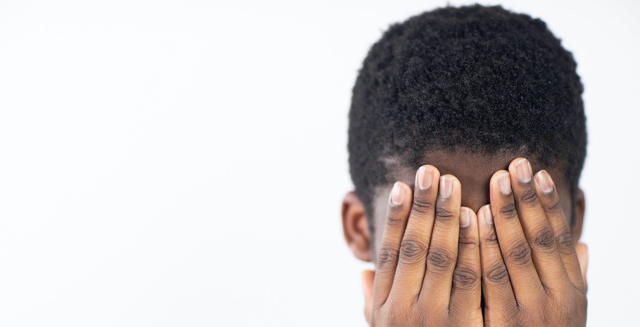 CBT for Phobias - African American boy covering his face with his hands