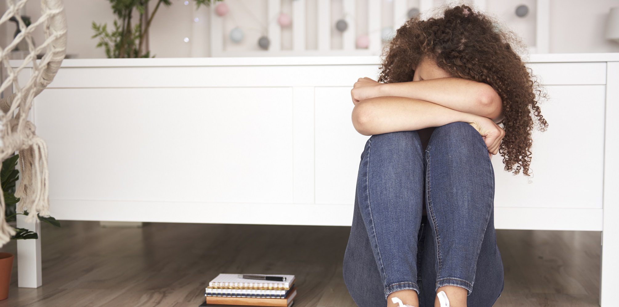 Teen breakups - Depressed teenager sitting on the floor