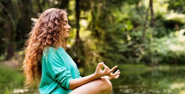 Girl practices yoga outside