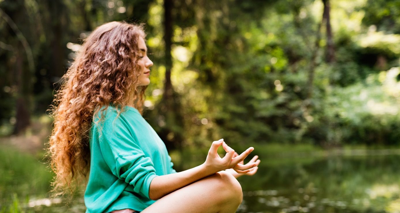 Girl practices yoga outside