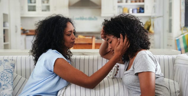 Situational Anxiety - Mother talking with stressed daughter on their couch
