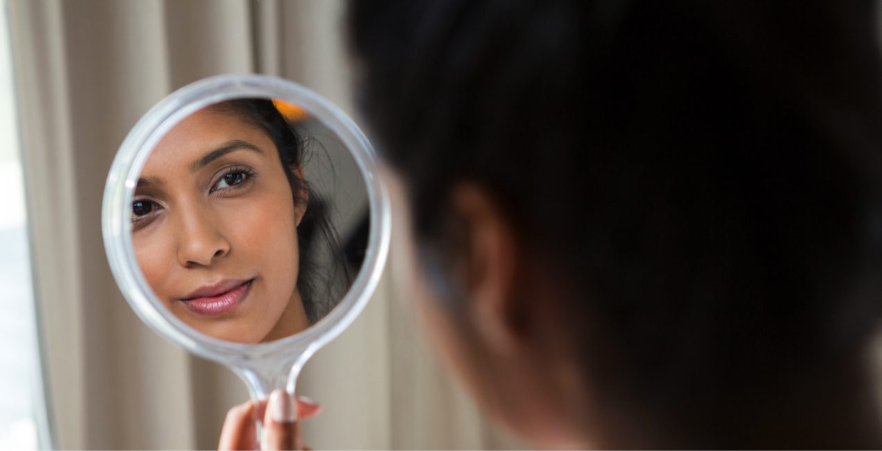 Grateful / Agradecido - Woman reflecting on hand mirror at home