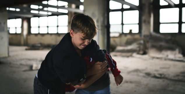 Conduct Issues / Disorder - grade school boy attacking or bullying another child inside an abandoned building