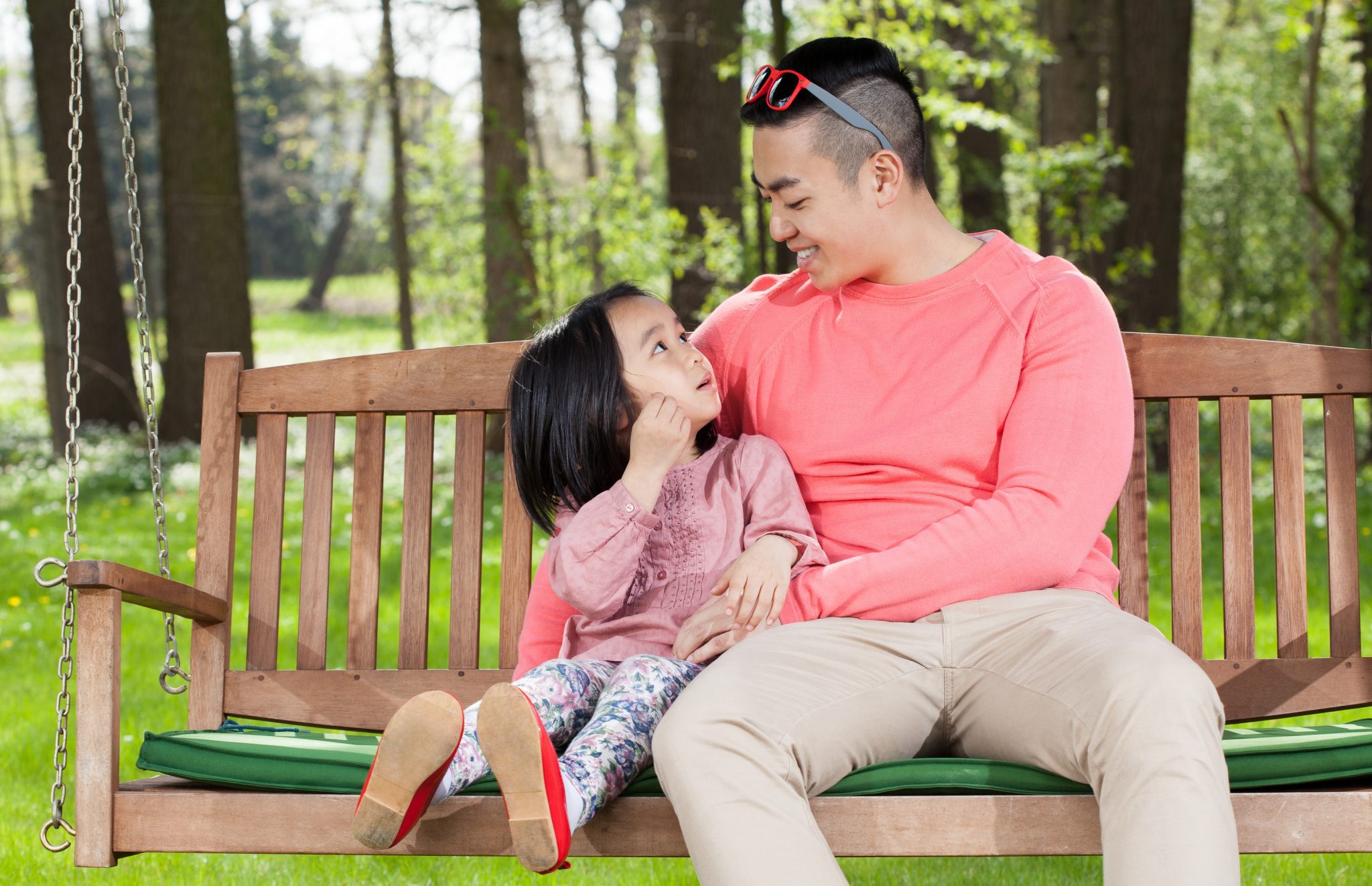 Building Mental Wellness Kids - Father and daughter have a conversation while sitting on a swing