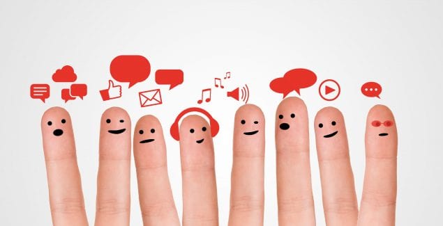 Happy group of finger smileys with social chat sign and speech bubbles. Fingers representing a social network.