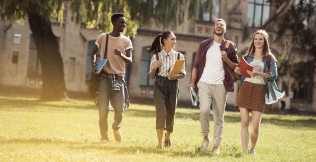 First-generation students - A multi-cultural group of college students walking together on