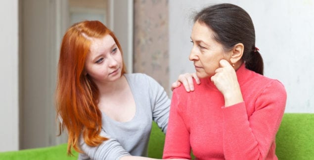 Teenage girl comforting her mother