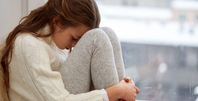 sad girl near window