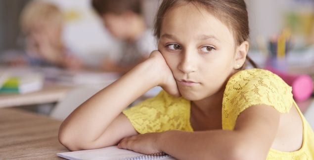 Girl sitting bored in class