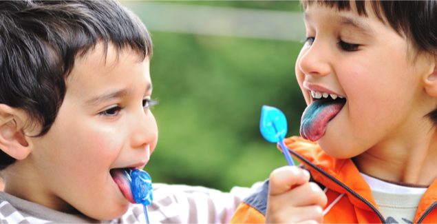 Two boys eating bright blue lollipops