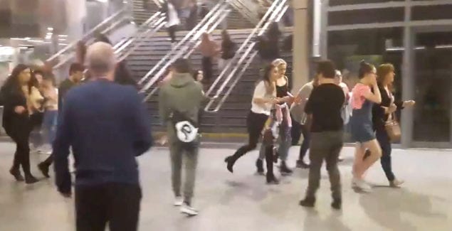 This image shows people running through Manchester Victoria station after an explosion at Manchester Arena. in Manchester England, Monday May 22, 2017. An apparent suicide bomber set off an improvised explosive device that killed over a dozen people at the end of an Ariana Grande concert on Monday, Manchester police said Tuesday May 23, 2017. The station is very near the arena. (Zach Bruce/PA via AP)