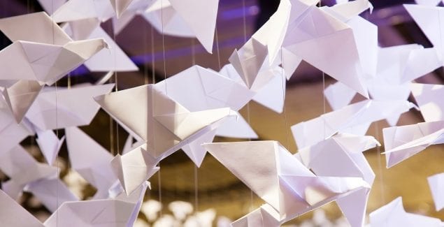 Kindness - Close up shot of many oragami paper cranes hanging mid-air