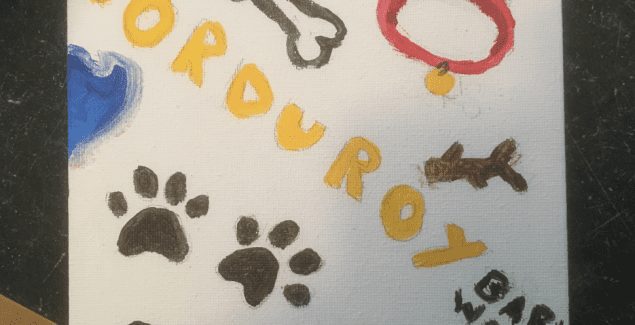 watercolor drawing with Corduroy's name surrounded by pictures of paws, a bone, his colloar, and a tennis ball.