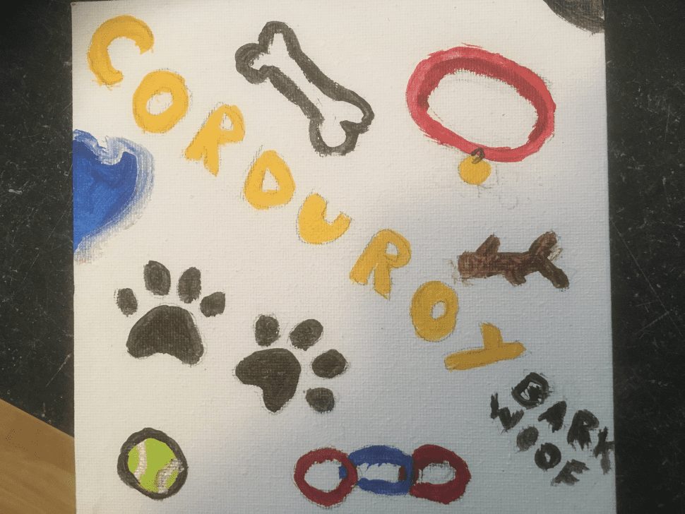 watercolor drawing with Corduroy's name surrounded by pictures of paws, a bone, his colloar, and a tennis ball.