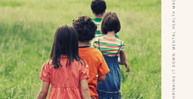 Young kids walking in a line into a green field