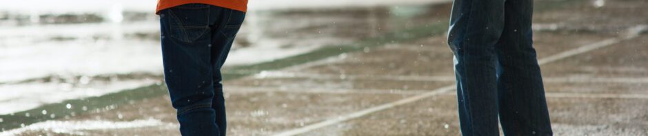 Storm Anxiety - Photo of two people standing in pouring rain on city street