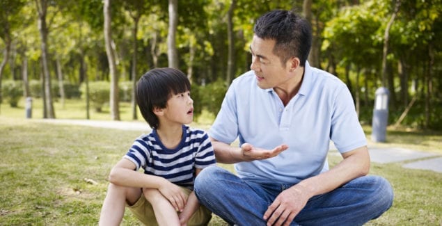 Talking About Asian Hate - Asian father and son sitting and talking outside