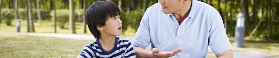 Talking About Asian Hate - Asian father and son sitting and talking outside