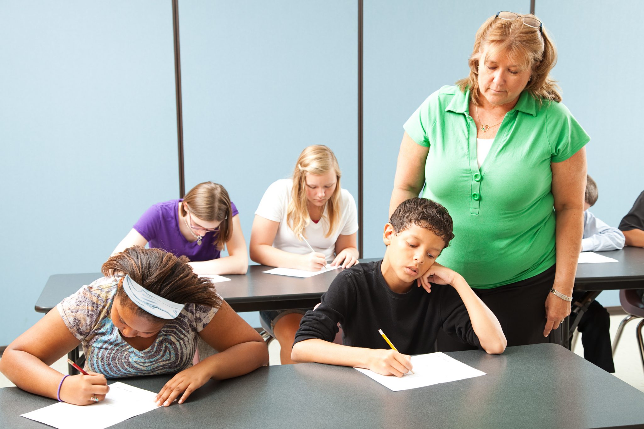Social emotional learning - Teacher supervising students who are taking a standardized achievement test.