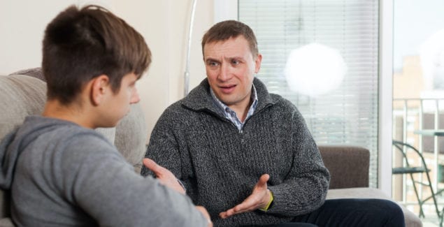 Father and teenage son having a tense conversation