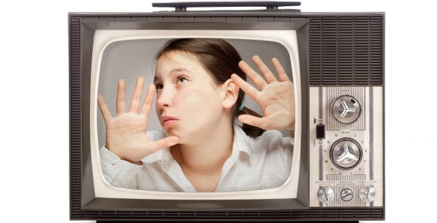 Girl trapped inside a retro portable TV over white background