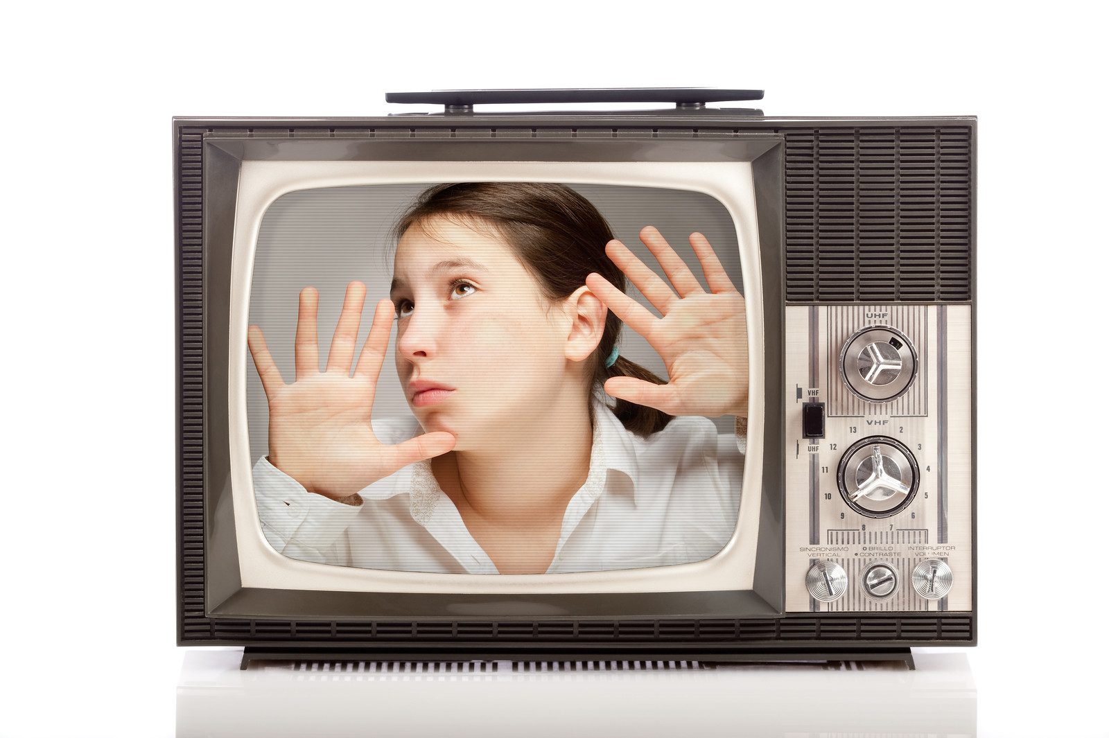 Girl trapped inside a retro portable TV over white background