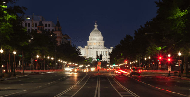 The United States Capitol building and Constitution Avenue in Washington DC at night