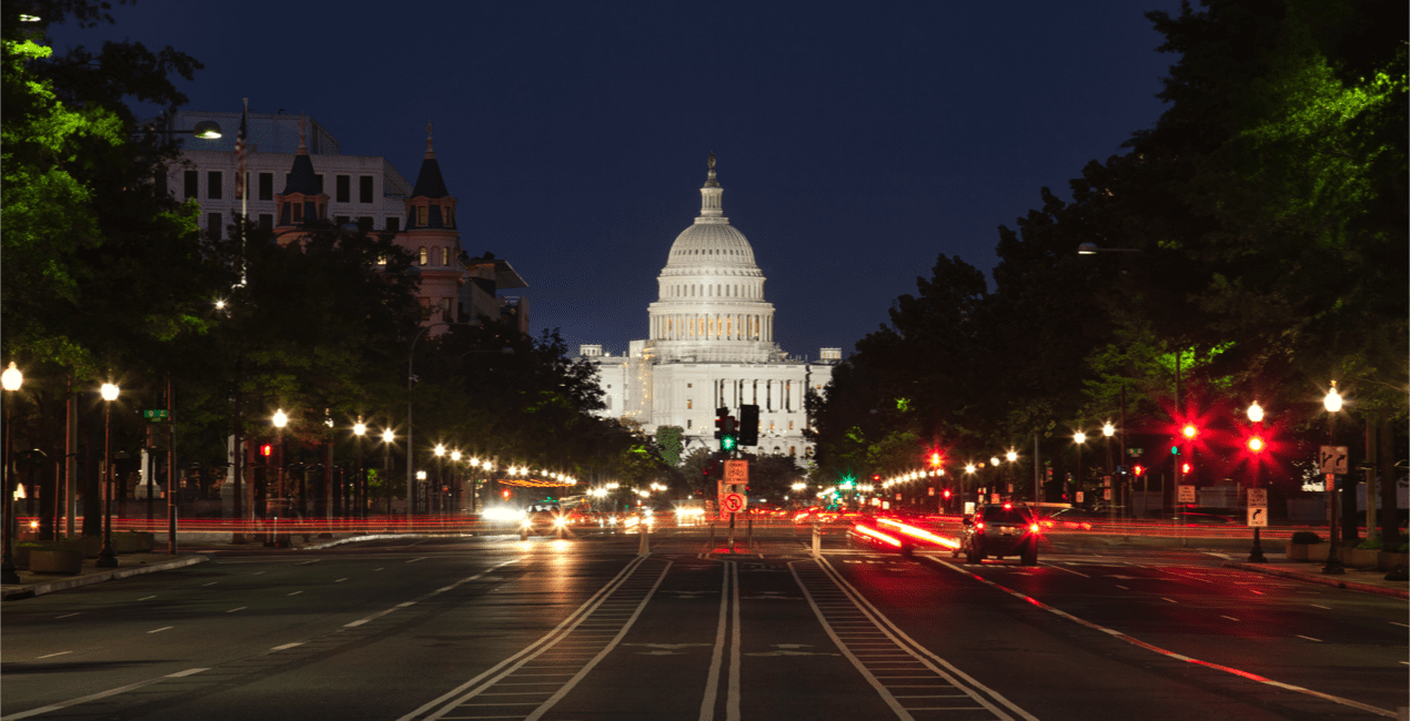 The United States Capitol building and Constitution Avenue in Washington DC at night