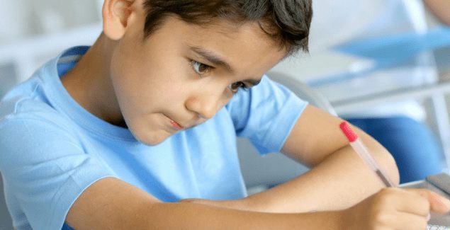 child writing in notebook