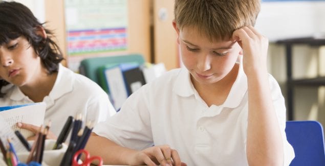 Schoolchildren reading books in class