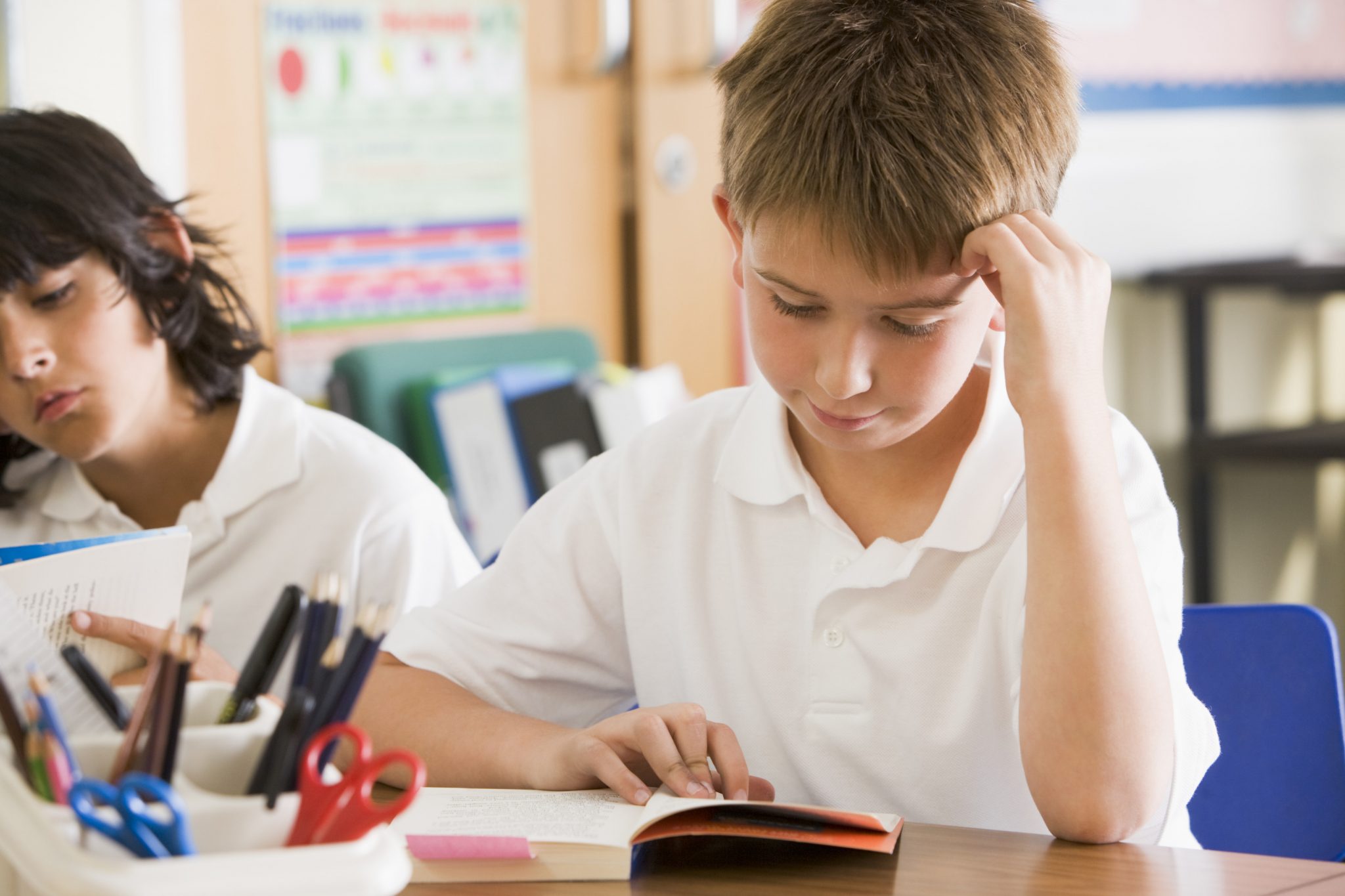 Schoolchildren reading books in class