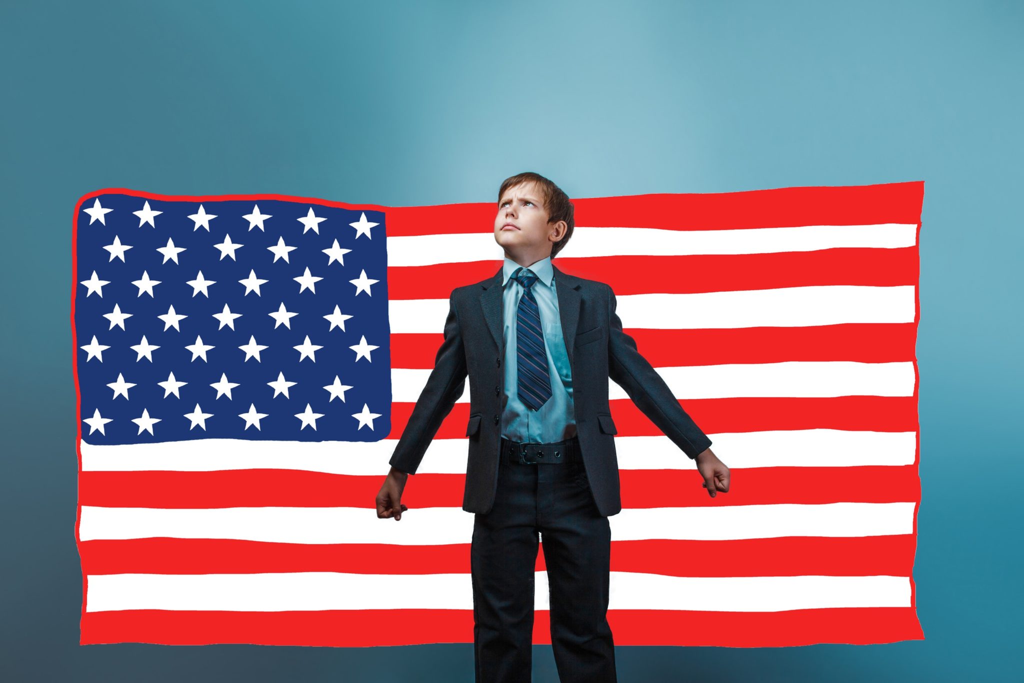 Image of a young child dressed in business suit looking authoritarian while standing in front of American flag backdrop