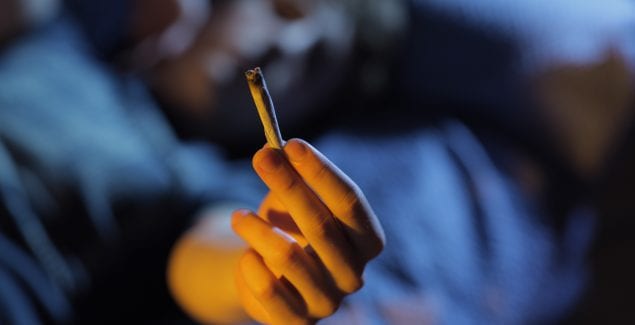 teen holding marijuana joint
