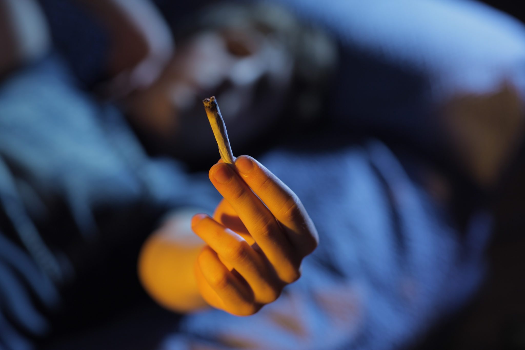 teen holding marijuana joint