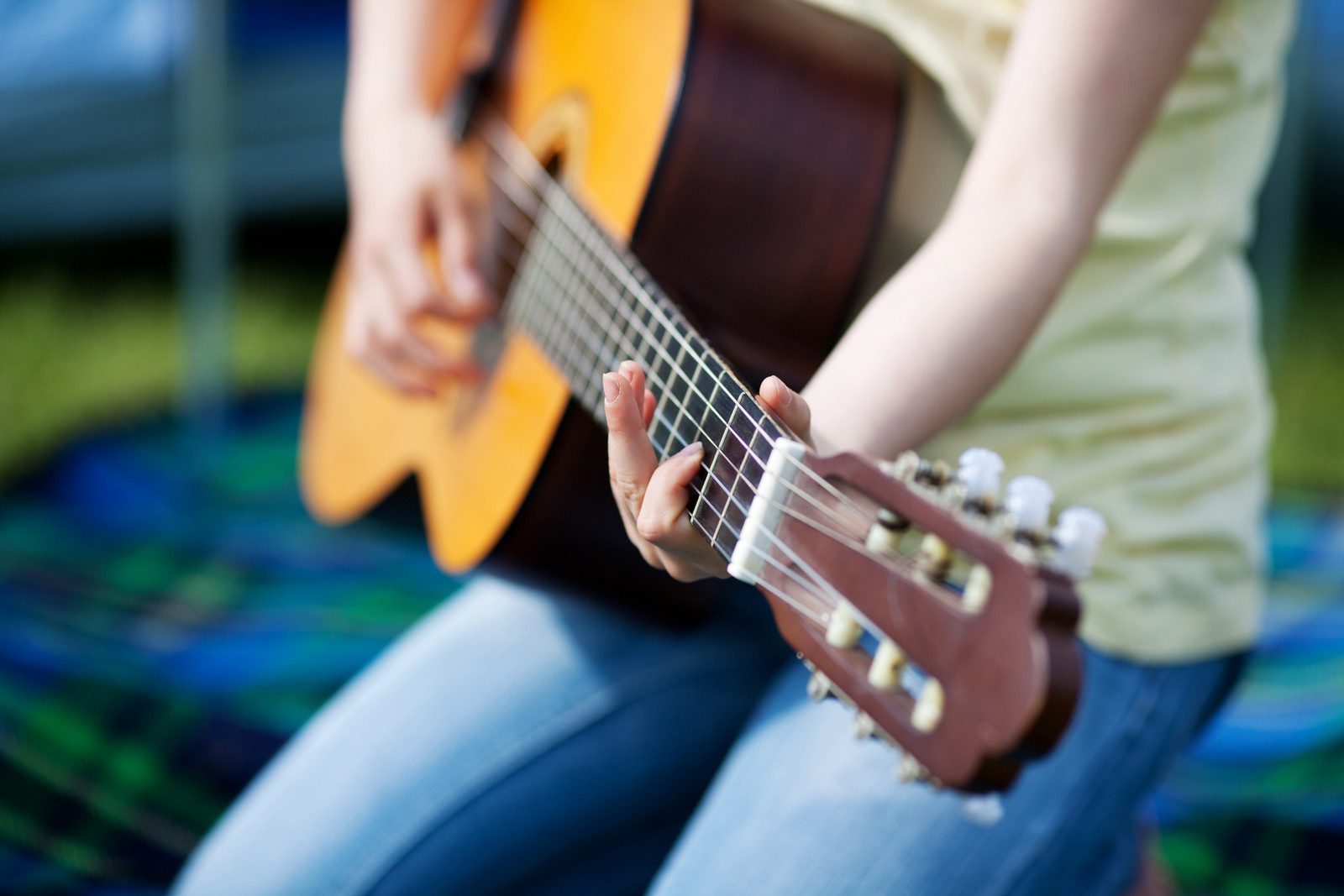 Young girl making music and playing guitar