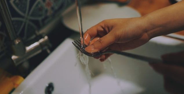 Kid washing silverware