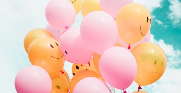 Mixed bunch of pink and orange smiley-face balloons