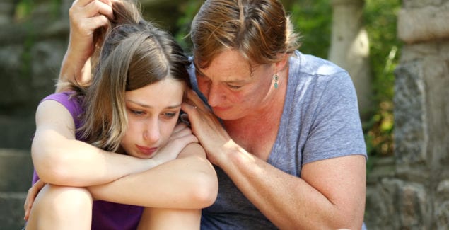 Mother comforting sad daughter