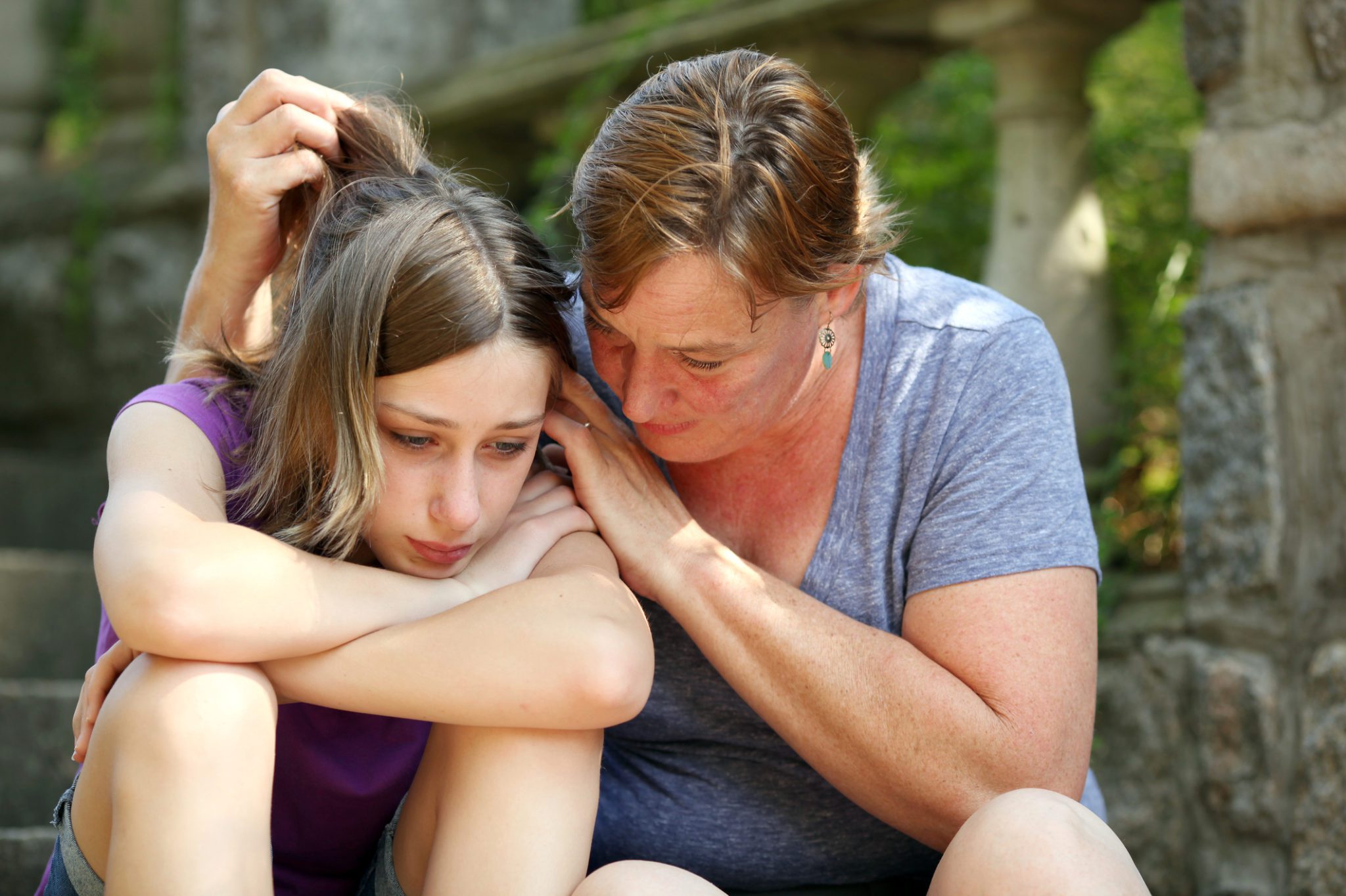 Mother comforting sad daughter