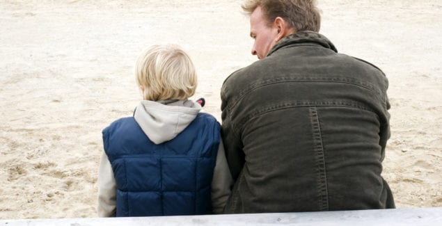 Father and son sitting together