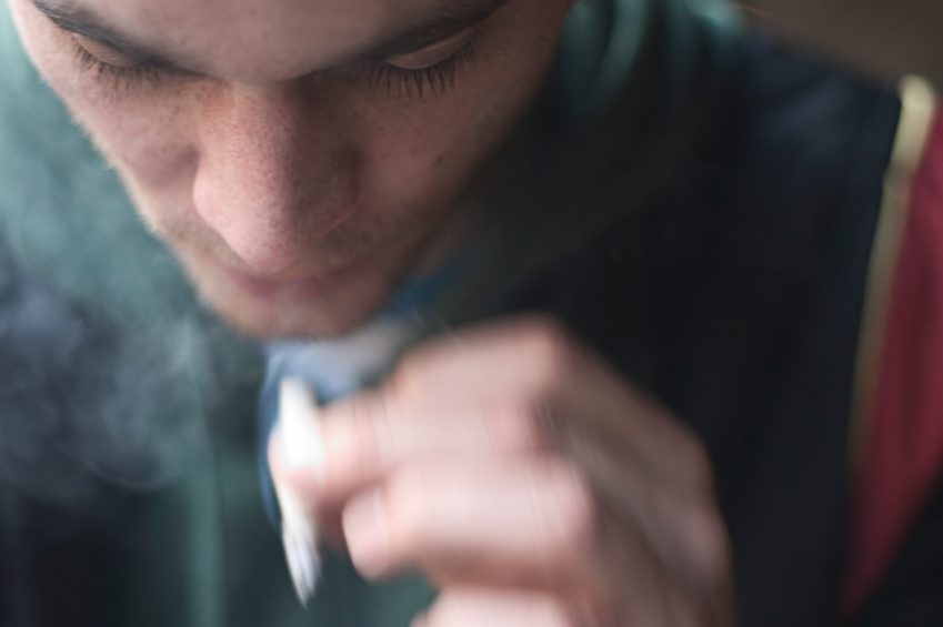 Marijuana, Ben's Story - Blurry close up image of teen smoking a joint