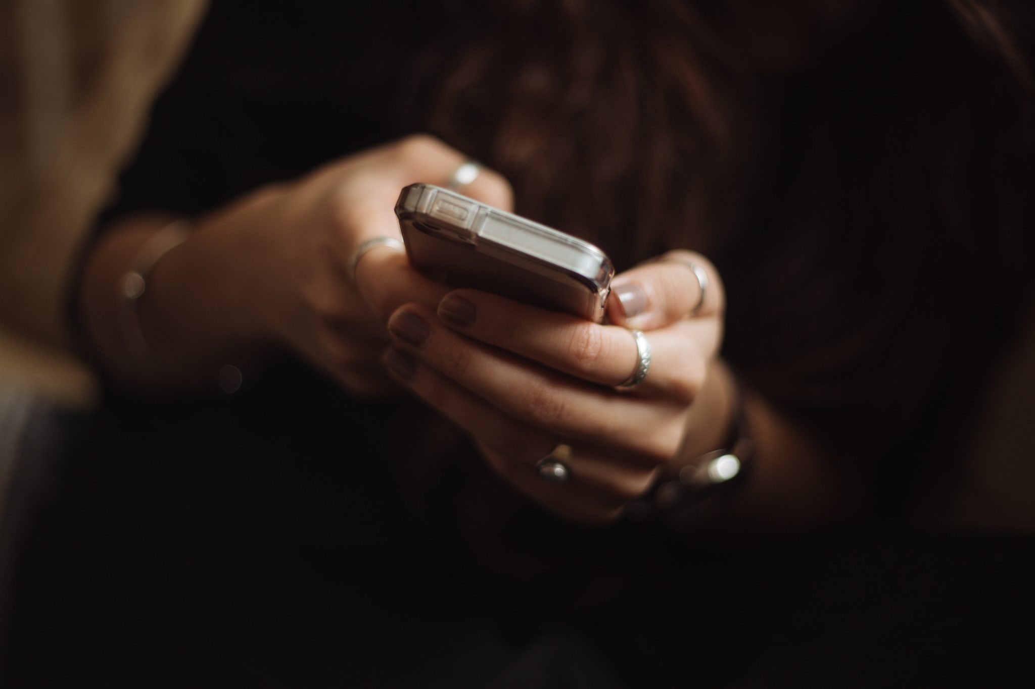 Closeup of young girls hands cupping a gripping a smartphone