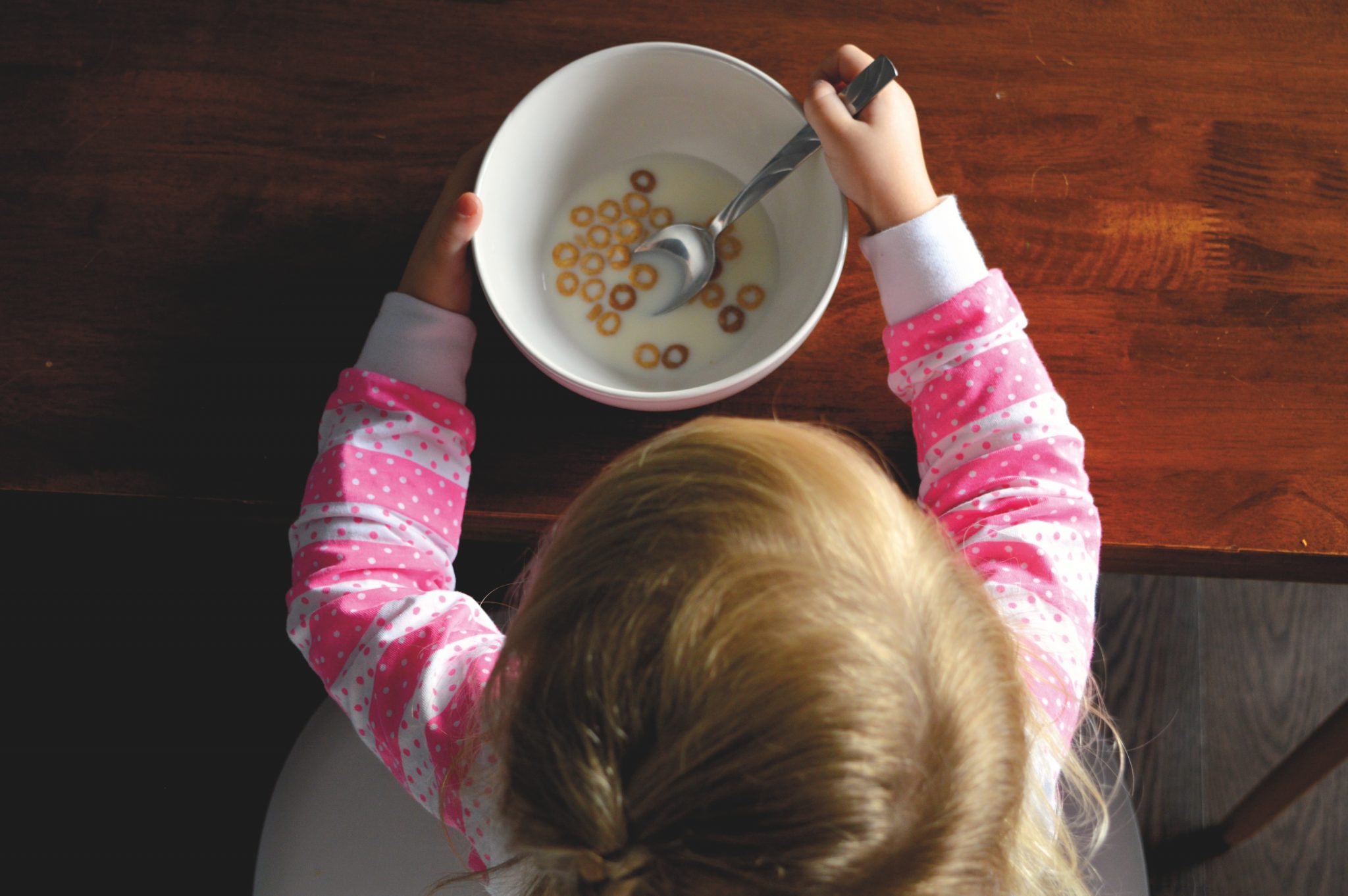 young girl eating cereal