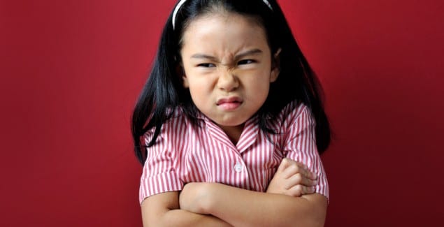 Oppositionality - young girl with arms crossed and angry look