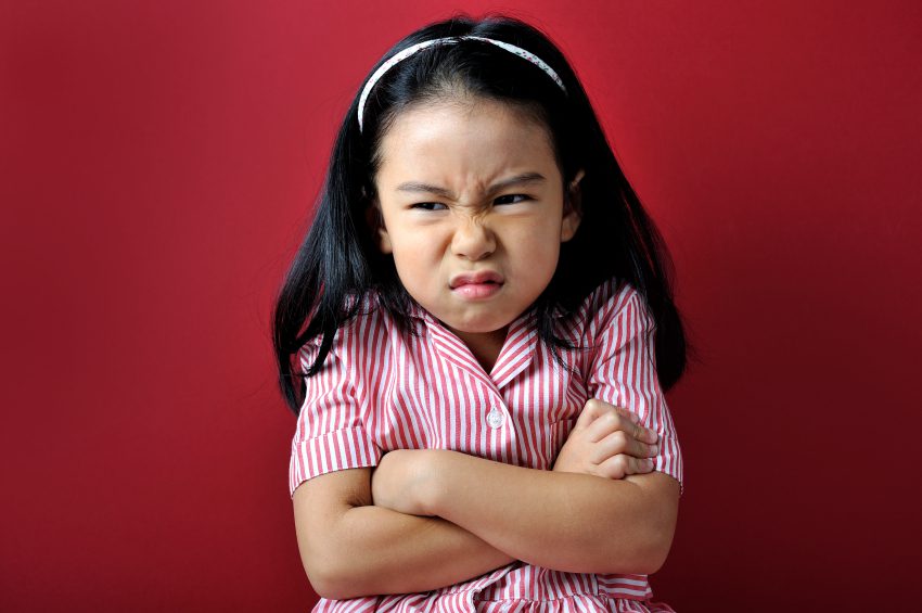 Oppositionality - young girl with arms crossed and angry look