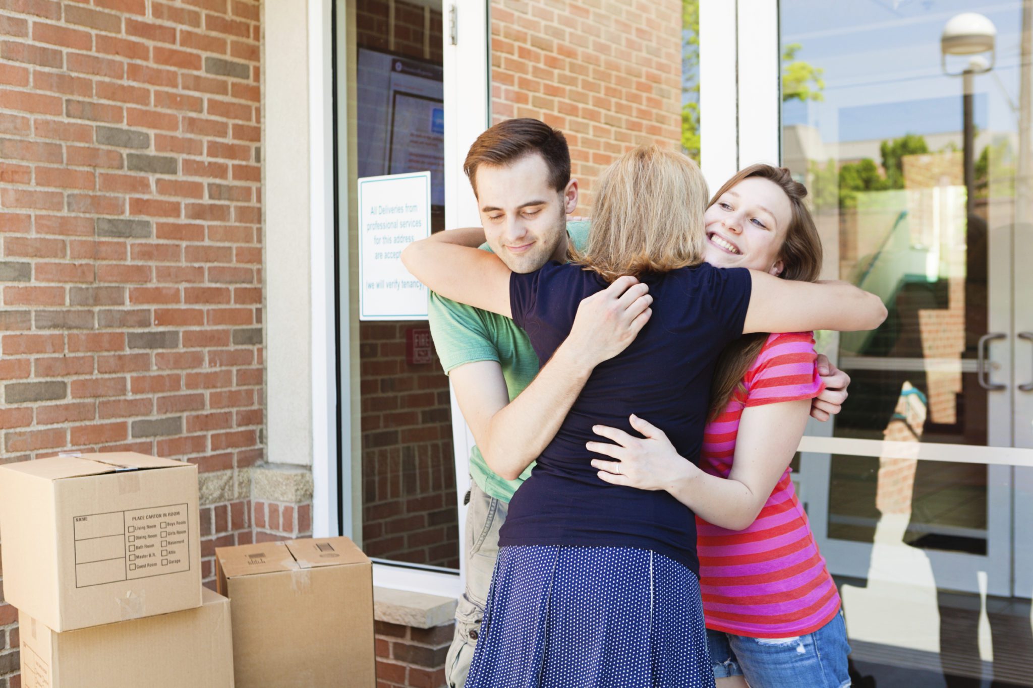 Kids leave home - Parents hugging goodbye their teenager